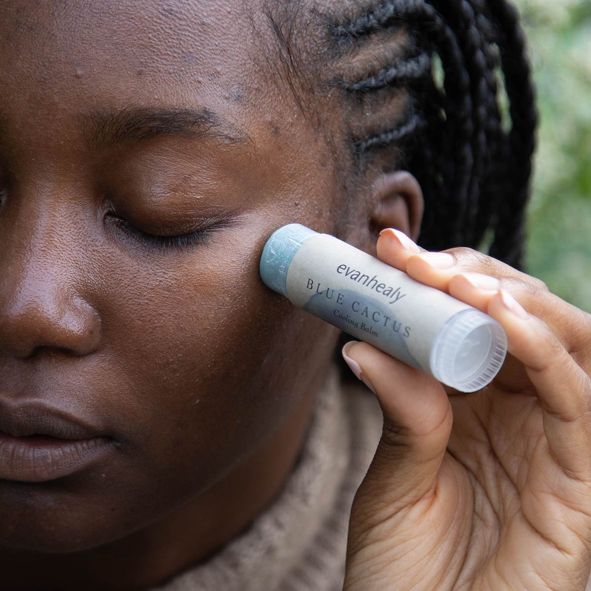 application of blue cactus cooling balm stick moisturizer on face