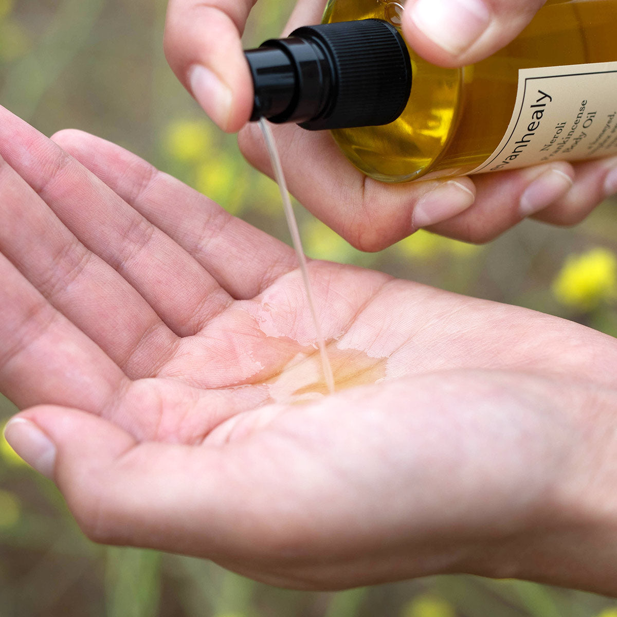 neroli frankincense body oil pumped into hand showing texture of moisturizer