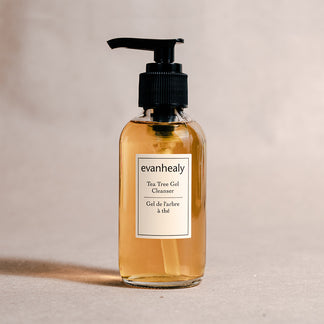 Front view of evanhealy Tea Tree Gel Cleanser bottle showcasing amber gel in a clear pump bottle with neutral beige background