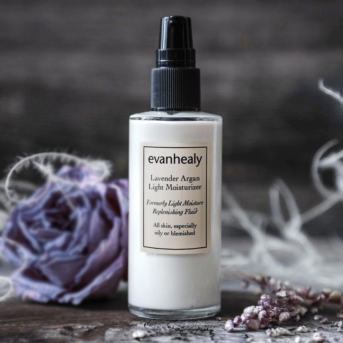 lavender argan light moisturizer on wooden surface with rose flower