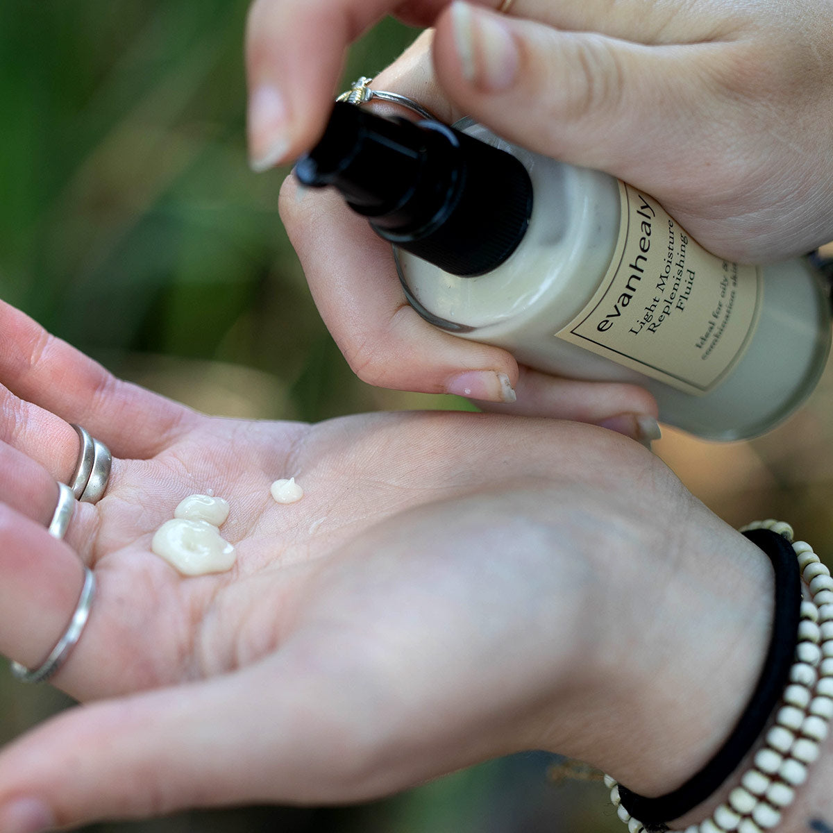 model pumping moisturizing lavender argan moisturizer in hand