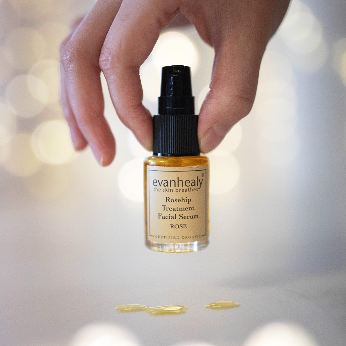 evanhealy rosehip rose facial treatment serum in fingertips