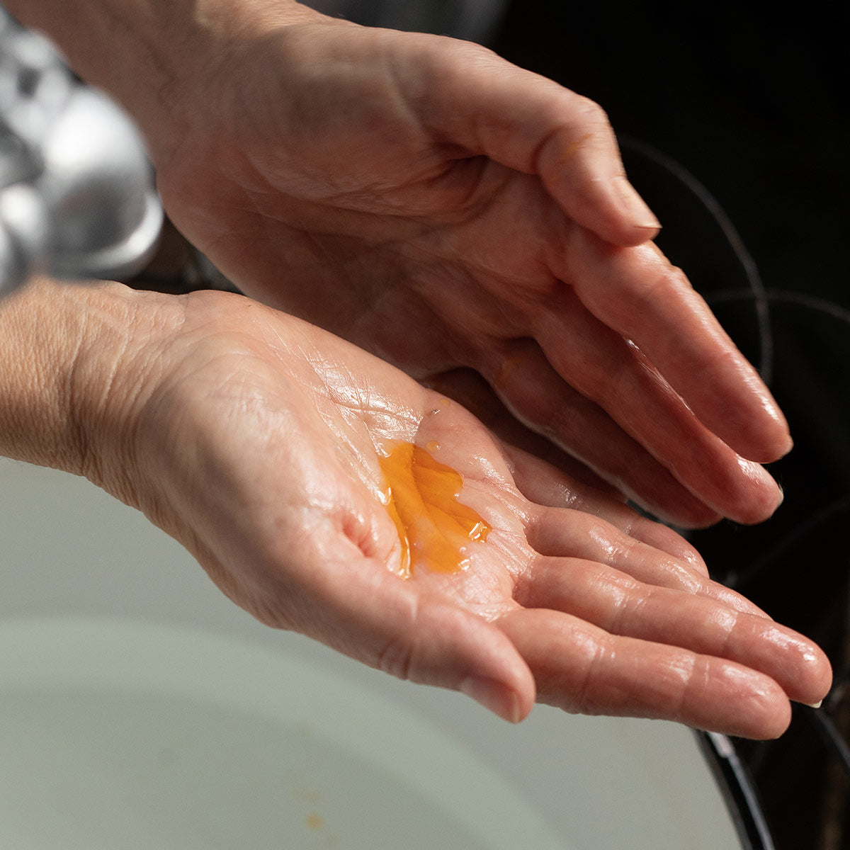 rosehip seed balancing oil serum texture in palm of hand