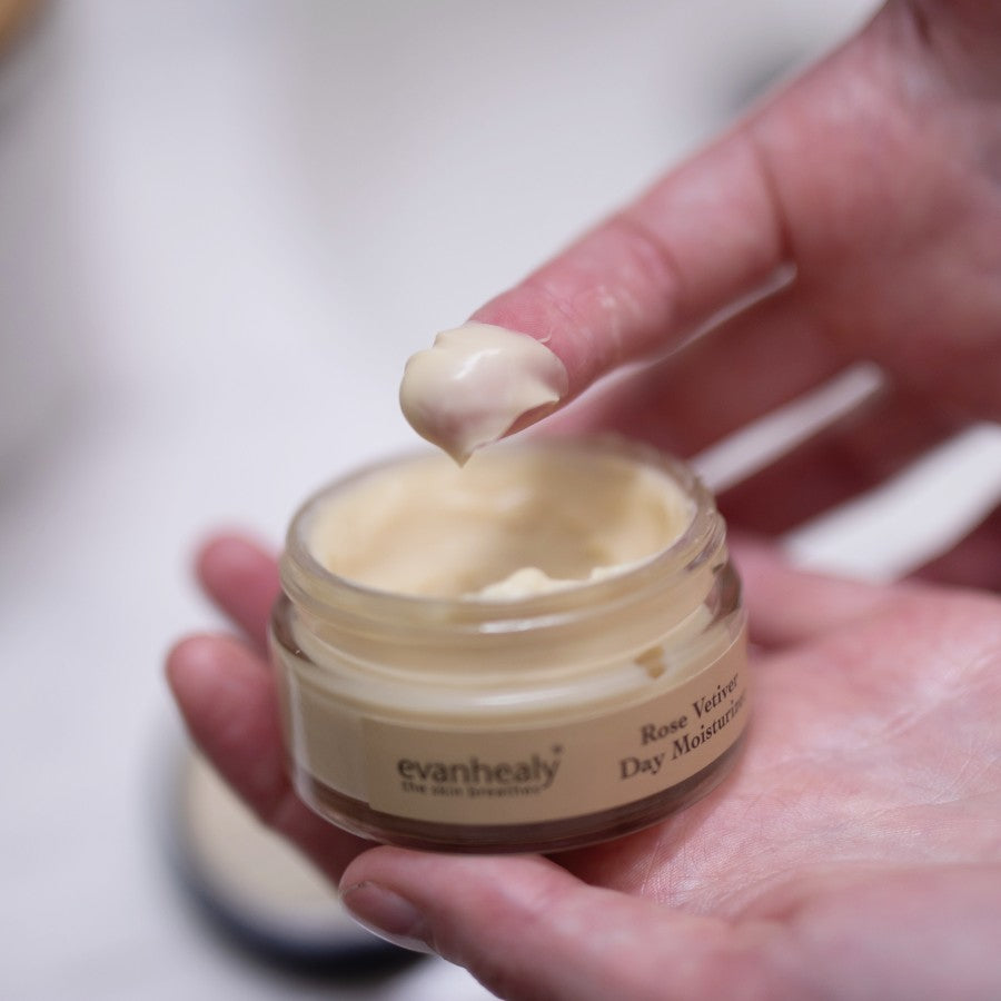 rose vetiver day moisturizer scooped out of jar with finger