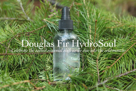 Front view of Douglas Fir Facial Tonic HydroSoul spray bottle with mist top and condensation over Douglas fir background