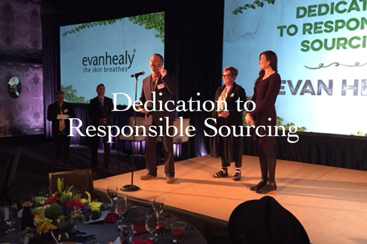 Group of speakers onstage addressing a seated dinner, projected slide reads “Dedication to Responsible Sourcing” with evanhealy logo