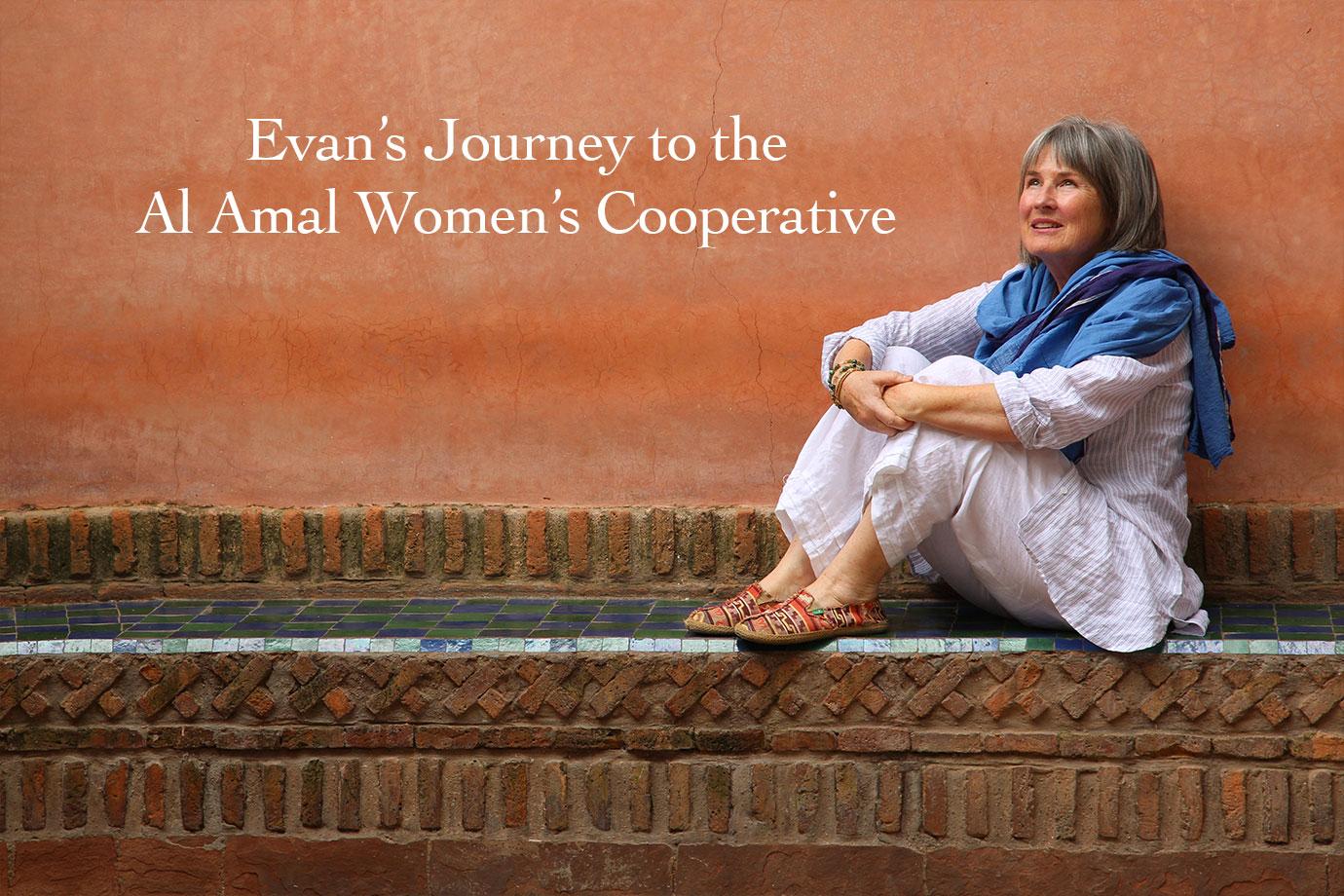 Woman seated on a tiled brick ledge against an orange plaster wall, wearing white linen and a blue scarf, looking up