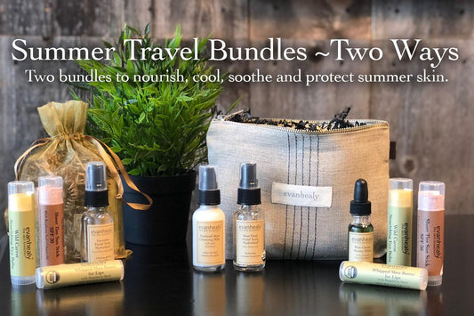 Two travel-sized evanhealy skincare bundles arranged with a canvas travel pouch and potted plant on a wooden tabletop backdrop