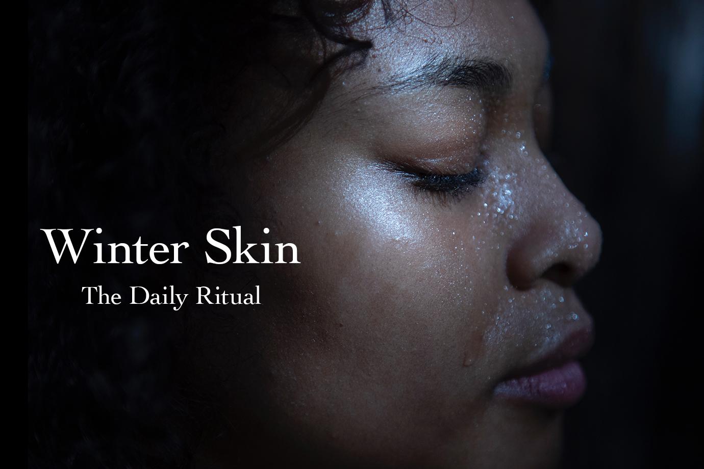 Banner showing close-up side profile of a woman with dewy skin and water droplets, with overlay headline Winter Skin — The Daily Ritual
