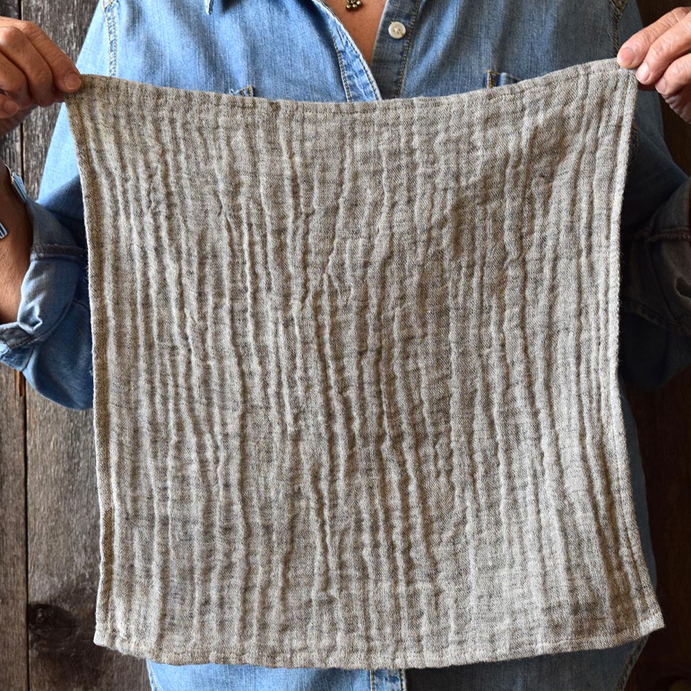 model holding 13 inch linen face wash cloth