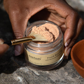 scooping french rose clay for jar with natural boar hair bristle fan mask brush