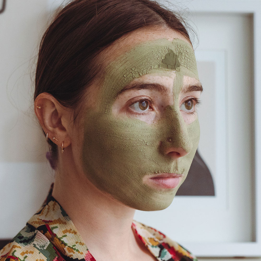 model wearing kimono with evanhealy green tea clay mask dried on face