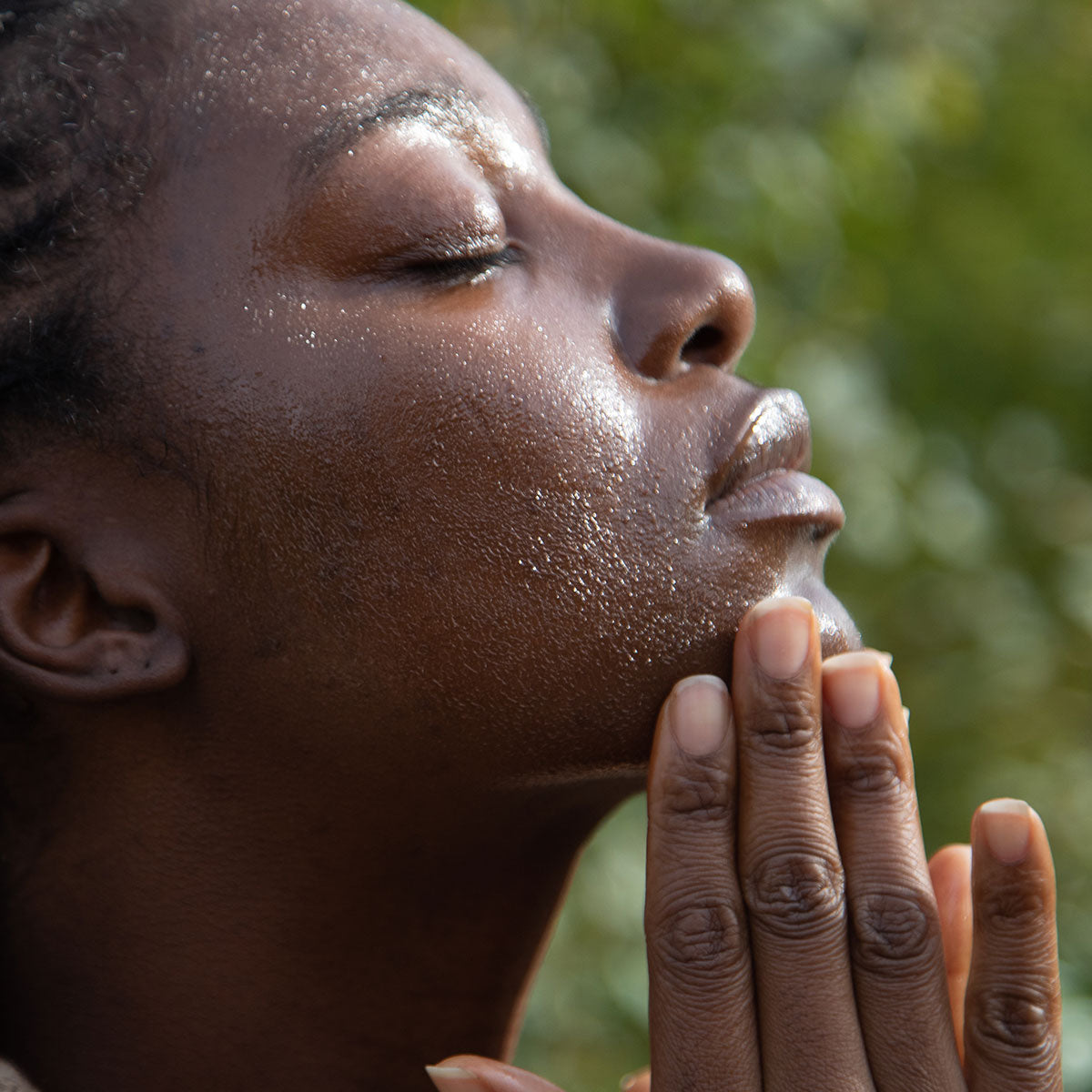 model applying nettle olive leaf cleansing oil facial cleanser to face