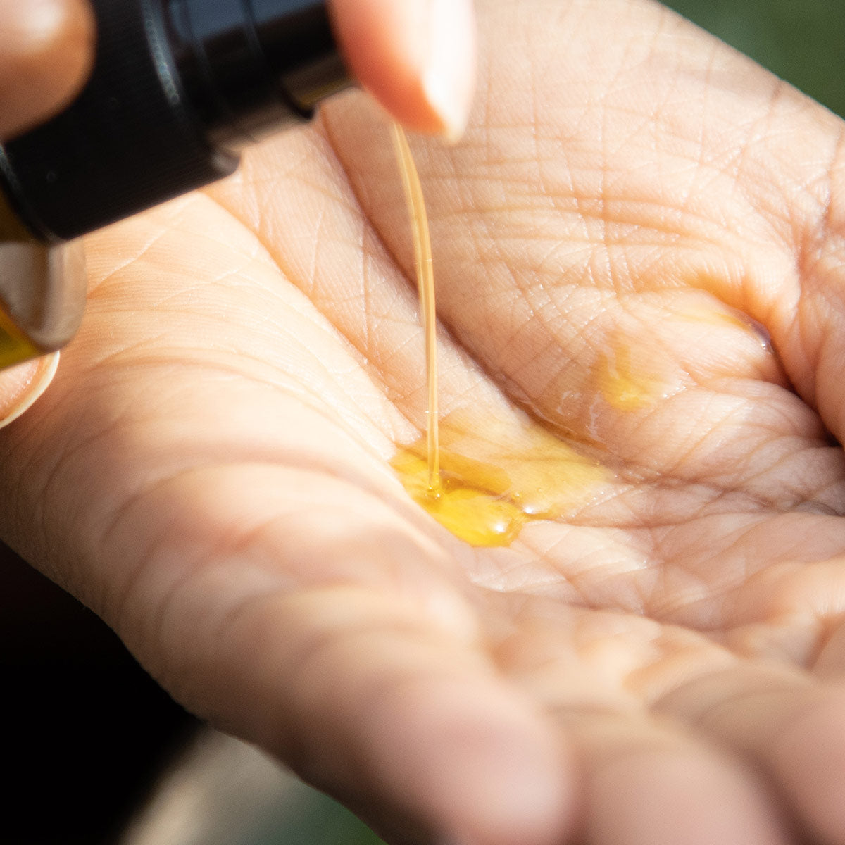 nourishing cleansing oil facial cleanser texture in palm of hand