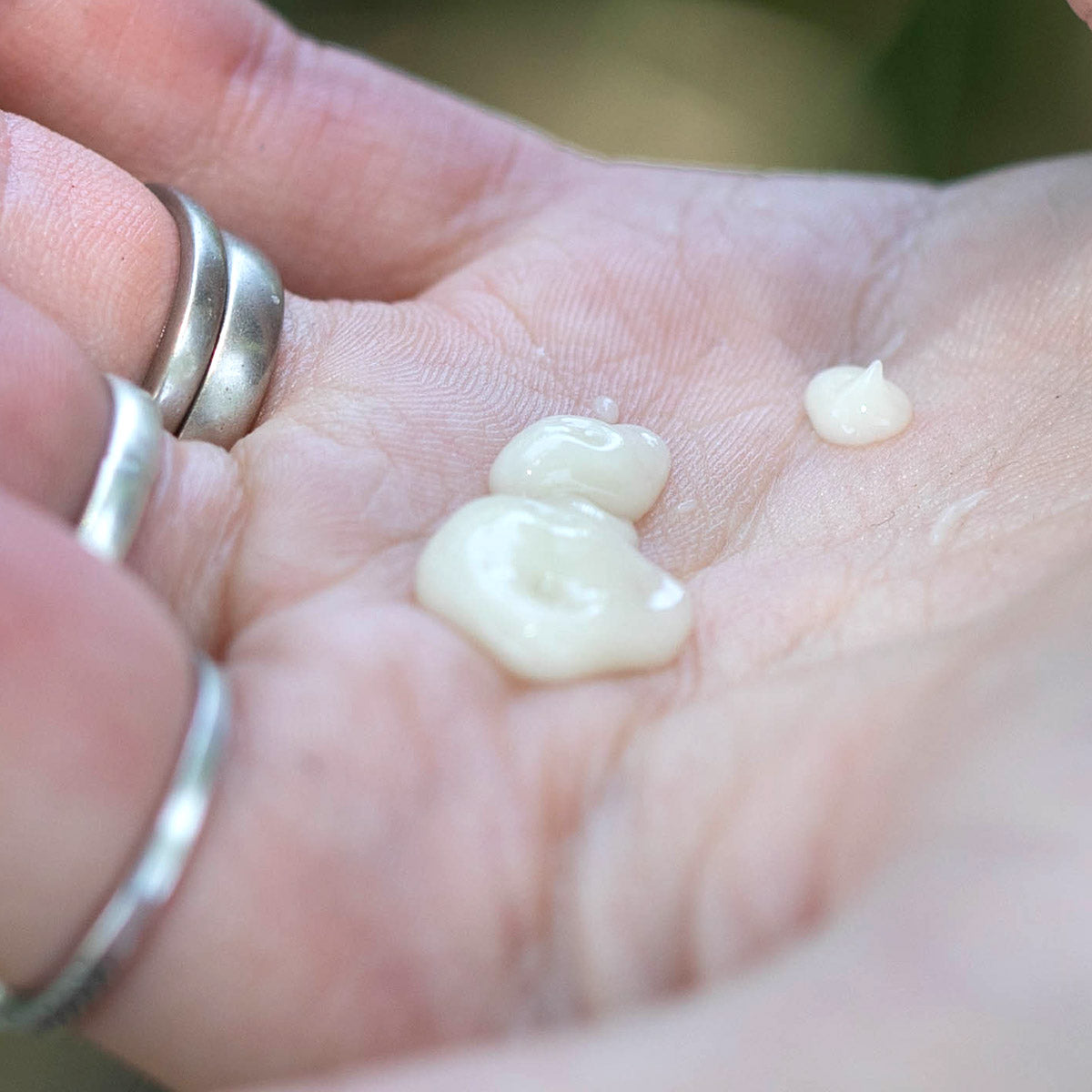 light moisture replenishing fluid texture in palm of hand