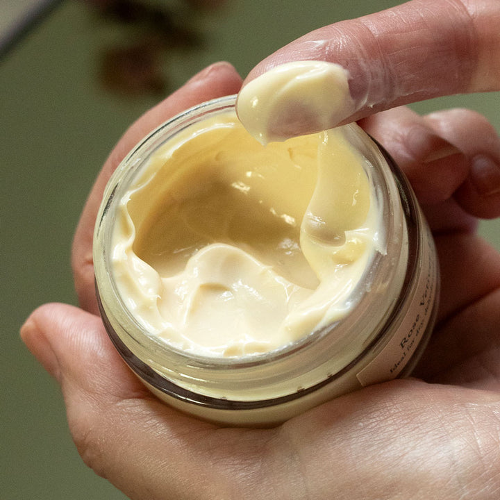 rose vetiver light facial moisturizer creamy texture on finger