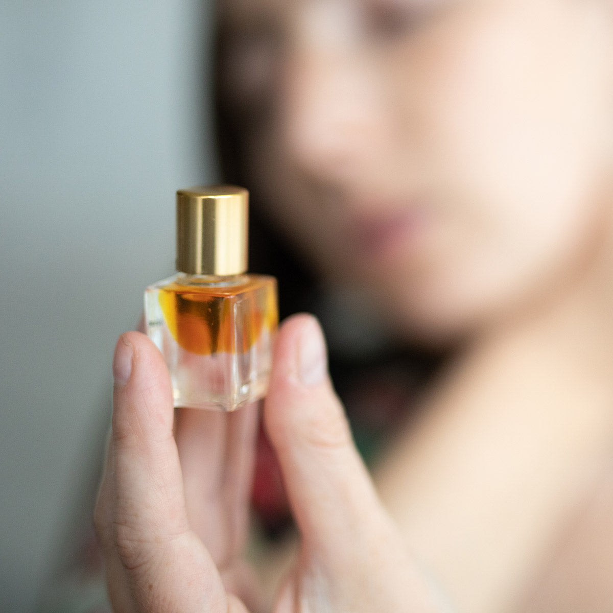 neroli blossom perfume in fingertips
