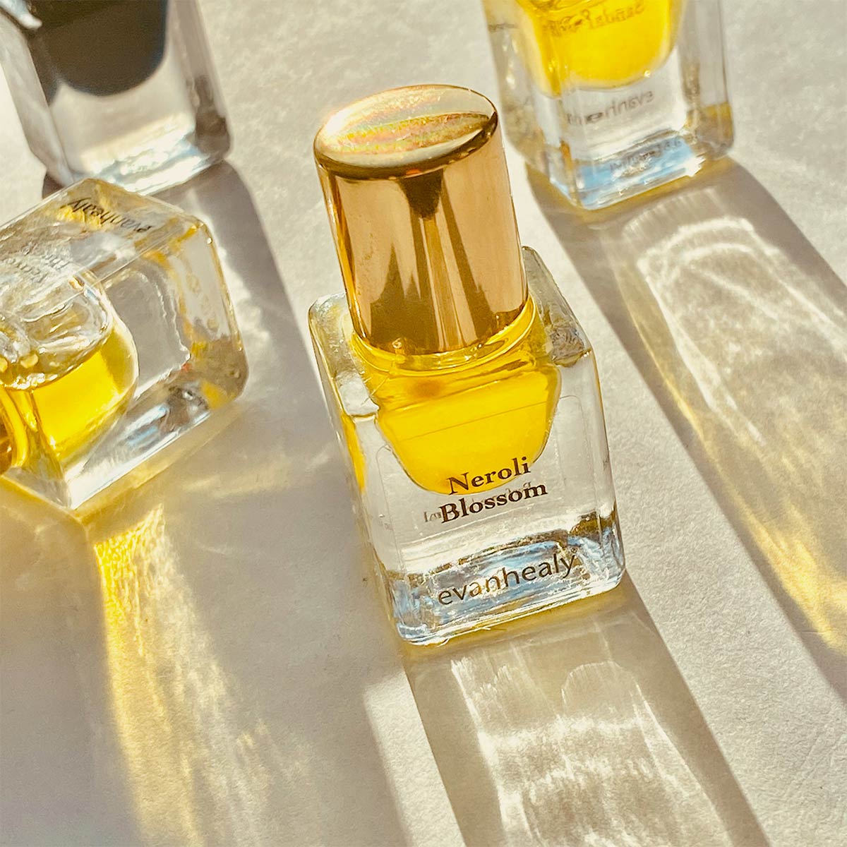 neroli blossom perfume with reflecting sunlight through bottle