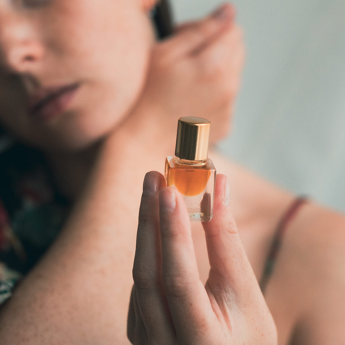 neroli blossom perfume in hand of model