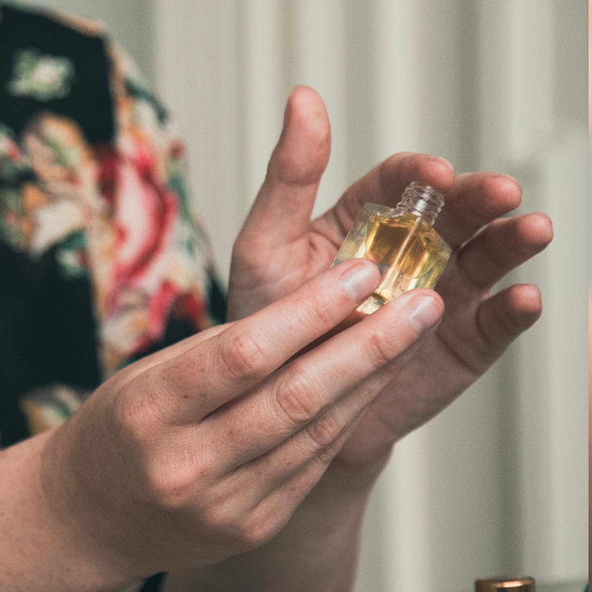 rose perfume on fingertip