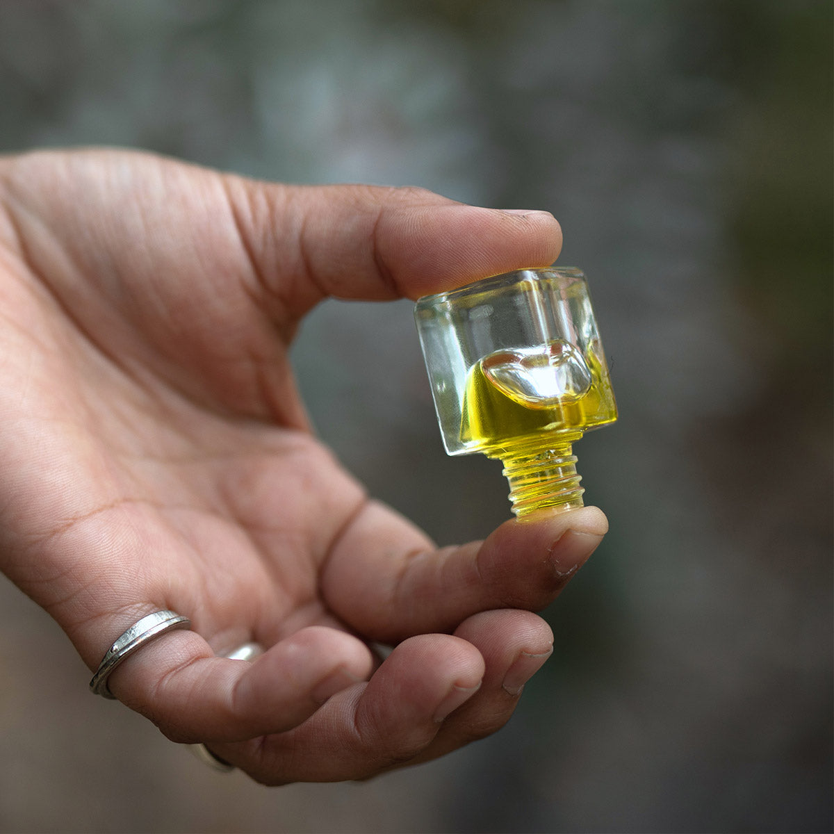 vetiver essential oil perfume tilted in fingertips