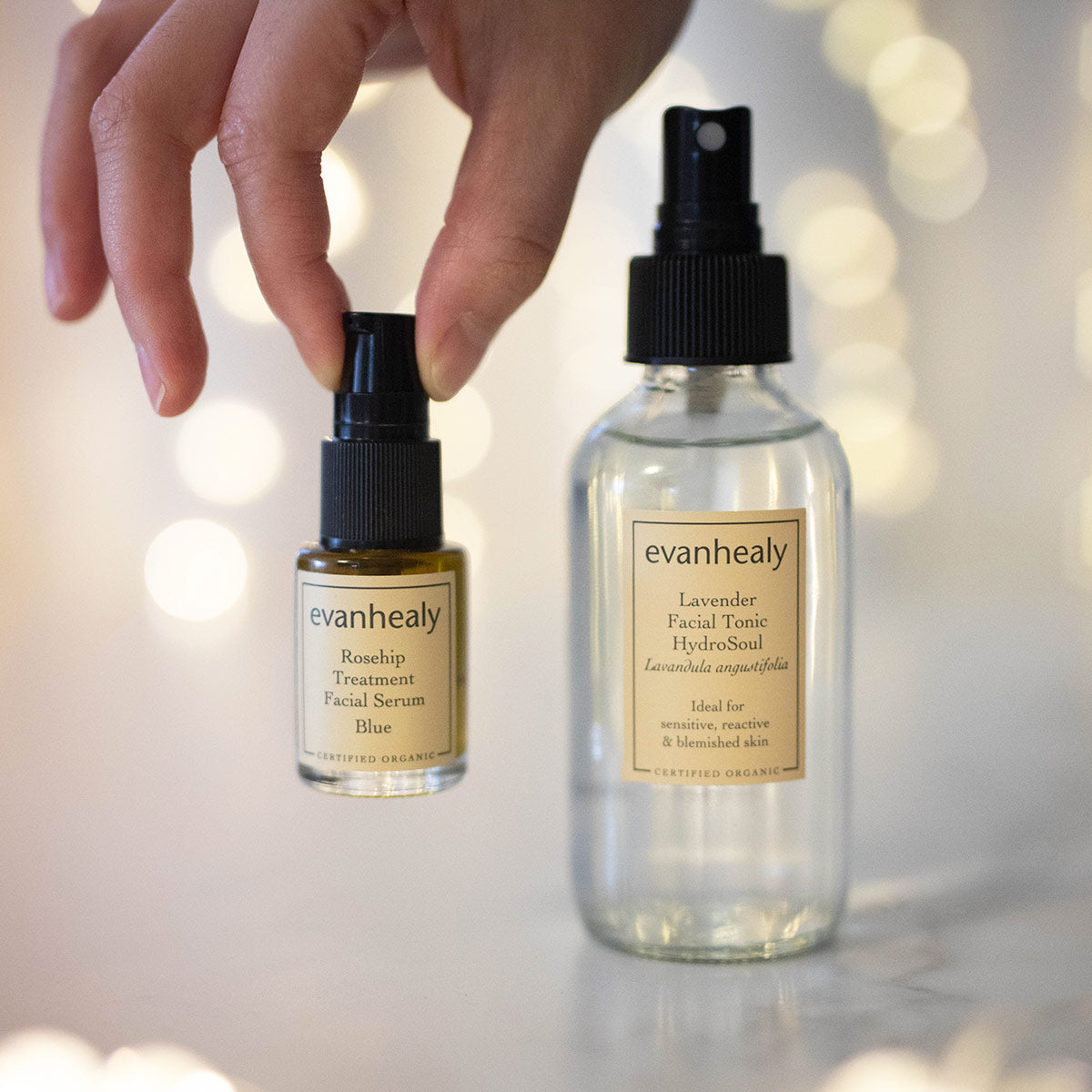 evanhealy calming ritual with rosehip blue oil serum in fingertips