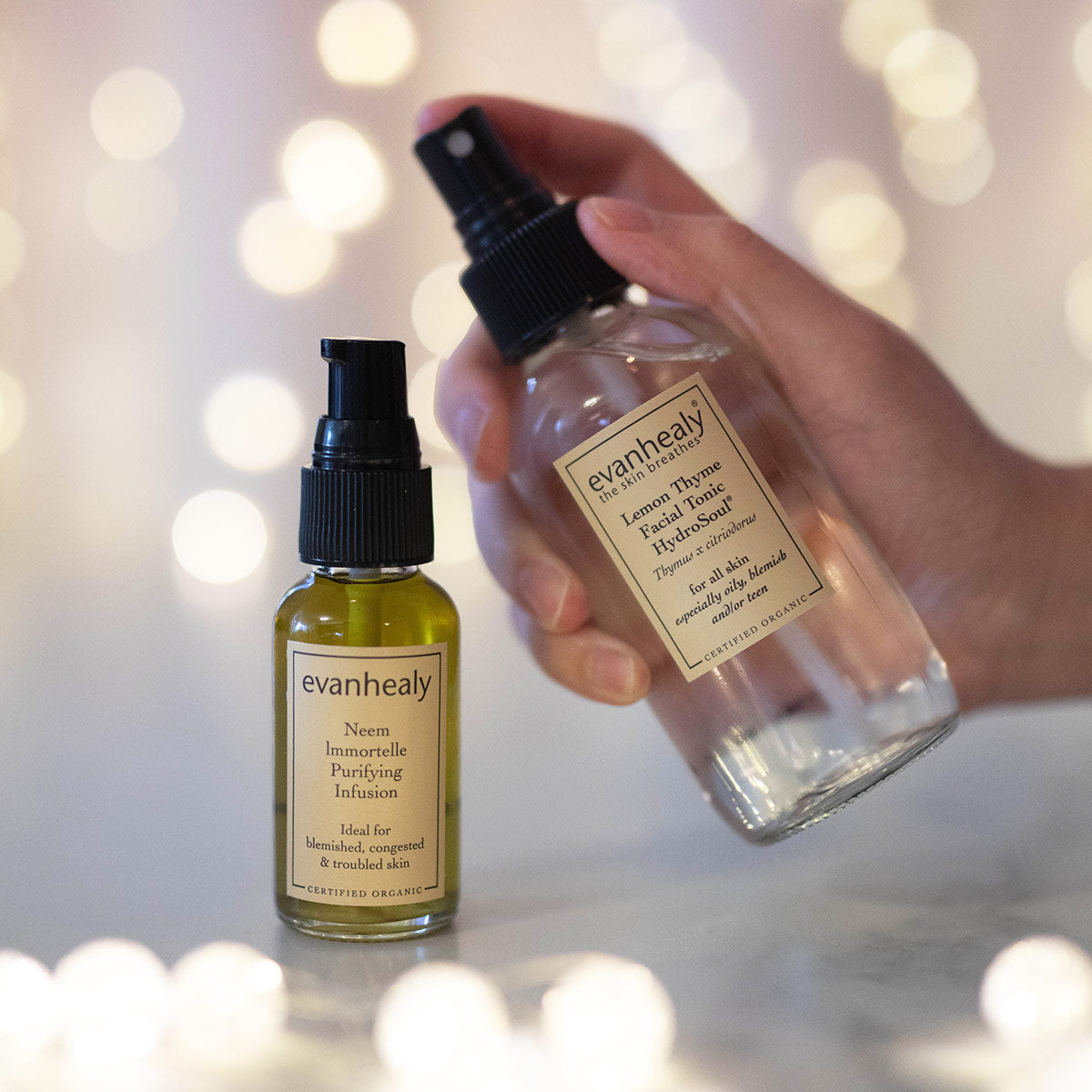 neem immortelle purifying infusion on surface with lemon thyme hydrosol in hand
