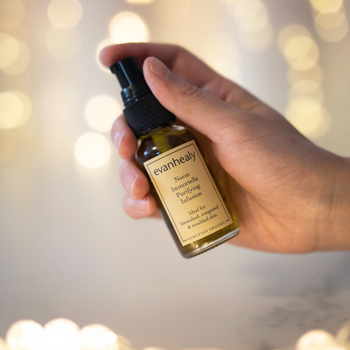 neem immortelle purifying infusion facial oil cleanser in hand