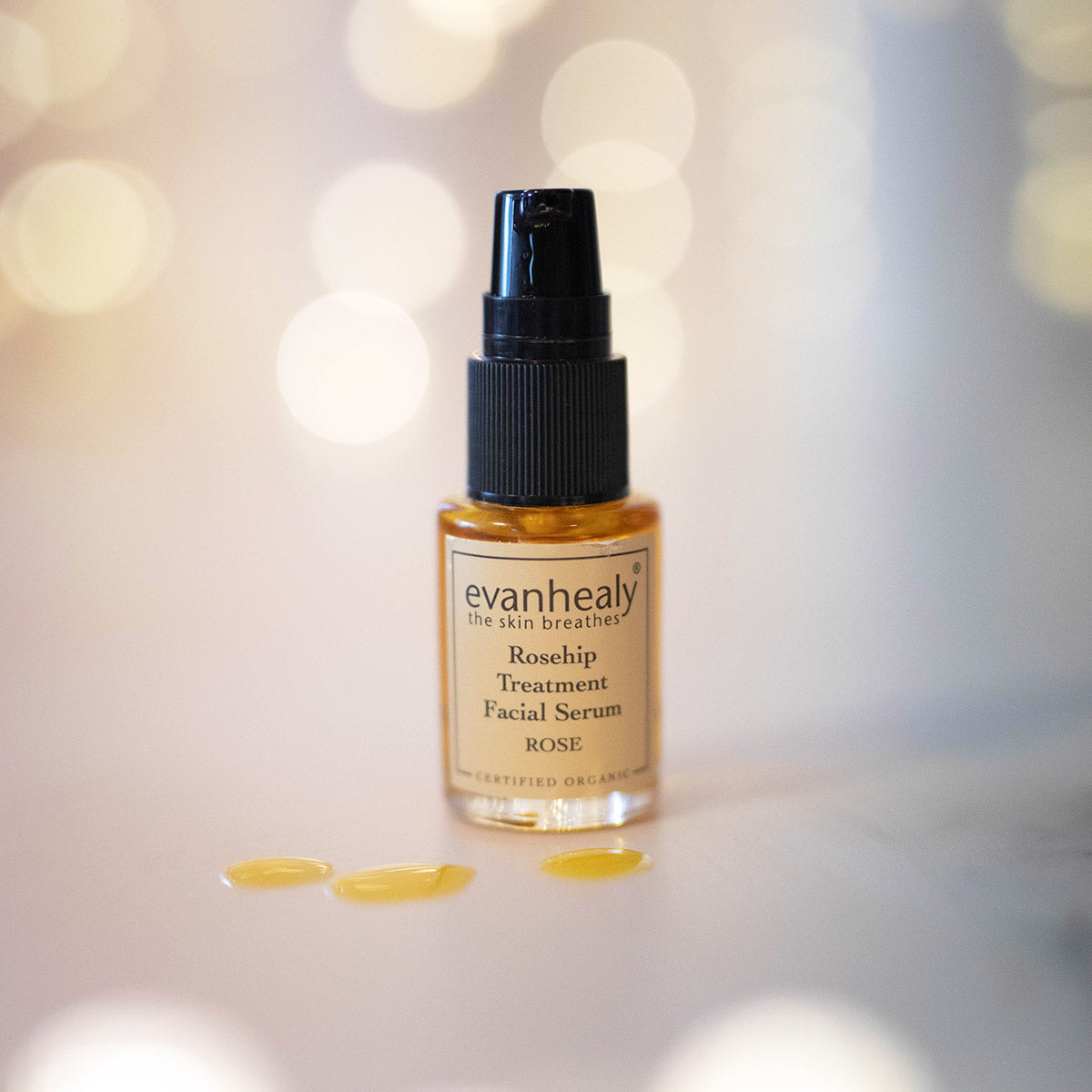 rosehip balancing serum for face with drops of oil on surface