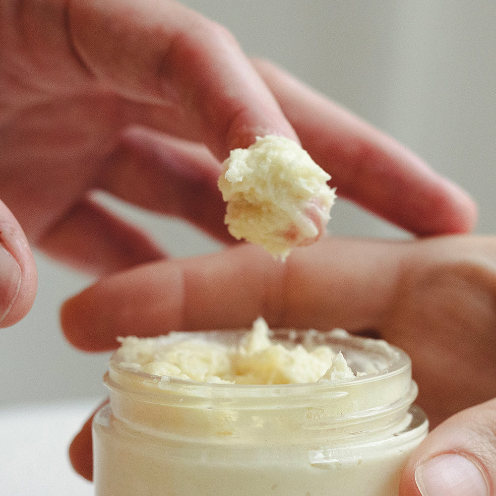 whipped shea butter on finger showing texture of moisturizer