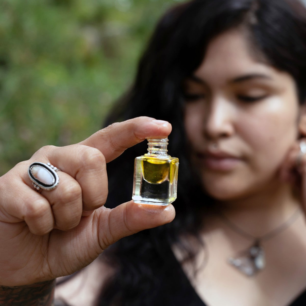 vetiver essential oil perfume in fingertips of model