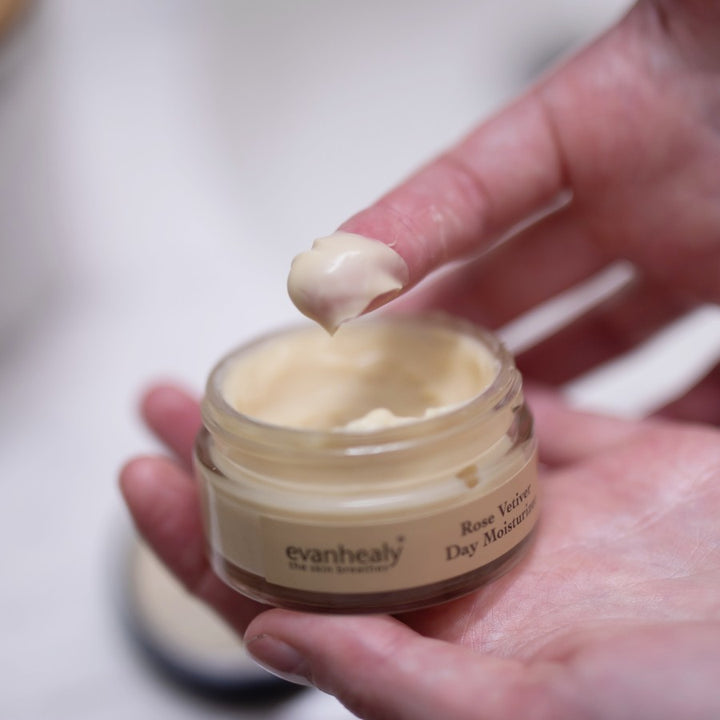 rose vetiver day moisturizer scooped out of jar with finger